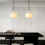 Warm stone glow from the alabaster pendant in a bedroom