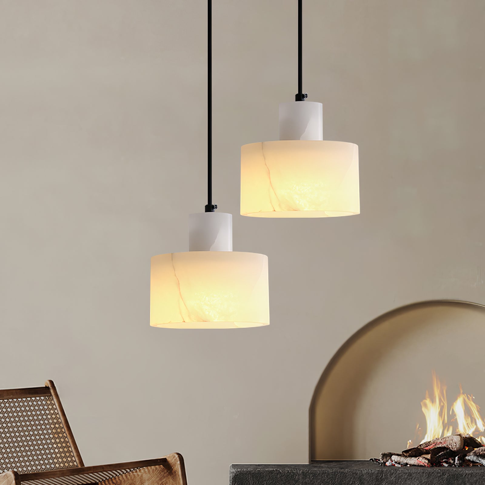 Hand-cut alabaster pendant light lit warmly on a plain backdrop