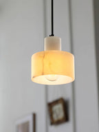 Hand-cut alabaster pendant light shown from below, veining visible
