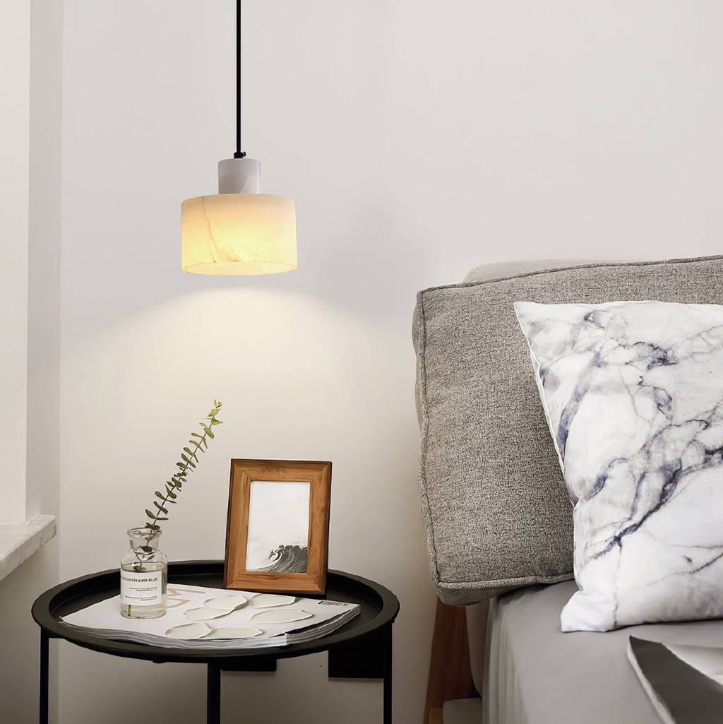 Warm alabaster pendant light glowing in a dim room