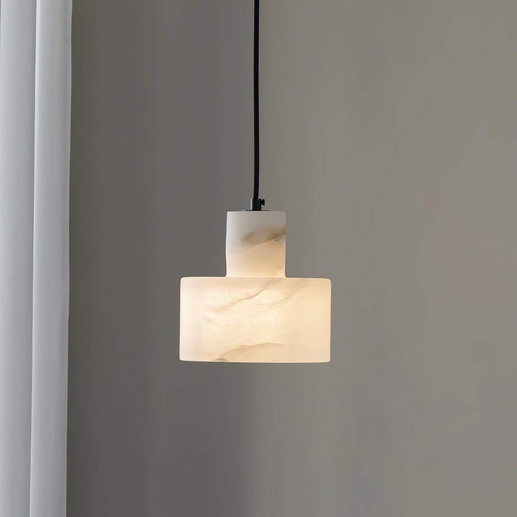 Alabaster pendant light suspended over a dining setting