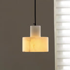 Alabaster pendant light hanging at the centre of a room