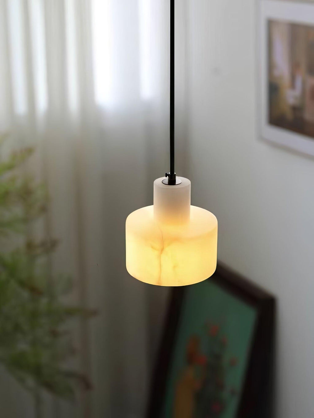 Alabaster pendant light suspended in a minimal interior