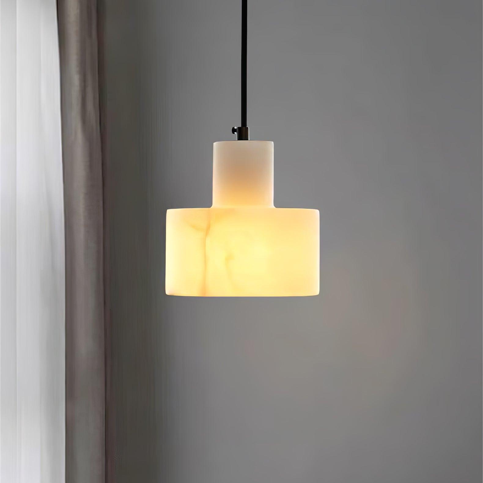 Alabaster pendant light hanging over a kitchen island