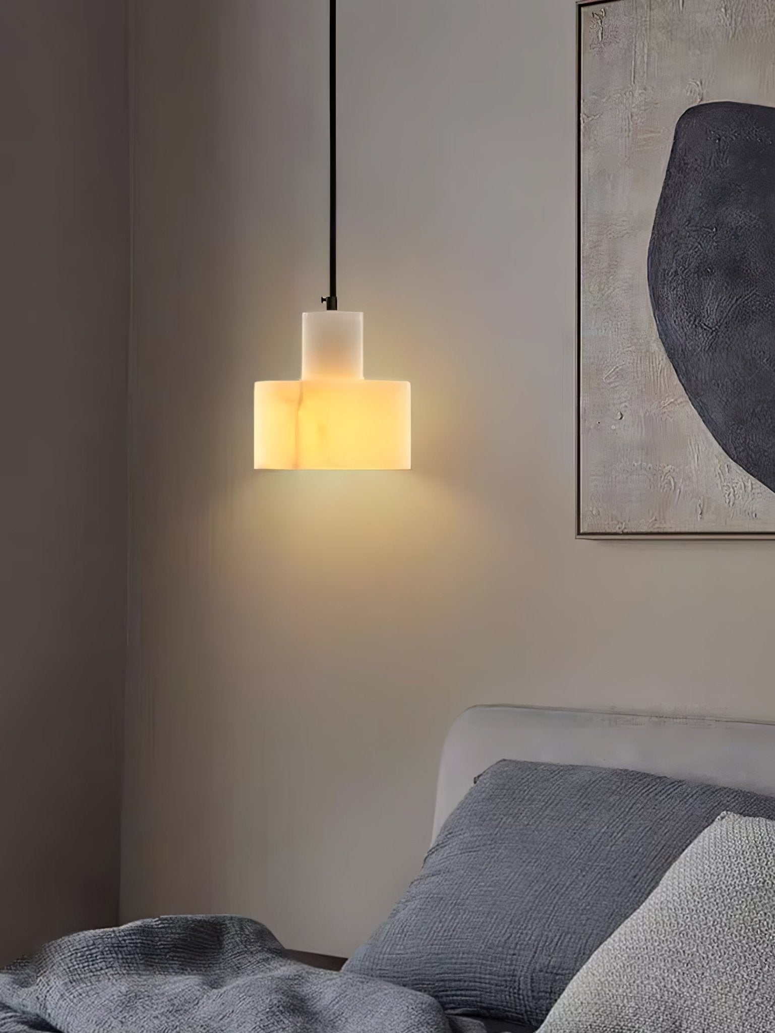 Alabaster pendant light glowing softly in an evening room