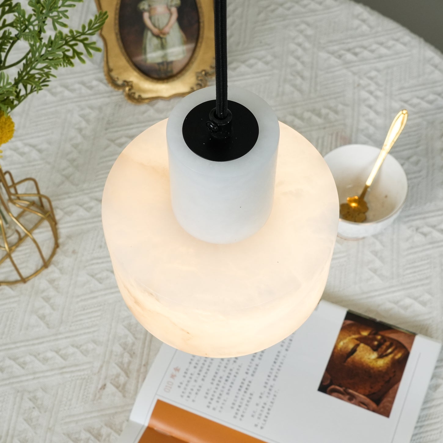 Alabaster pendant light shown in a minimal styled interior