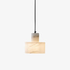 Hand-cut alabaster pendant light suspended above a nightstand