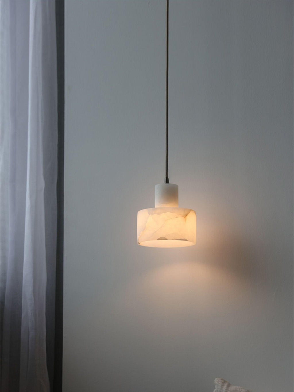 Warm glow filtering through the translucent alabaster shade