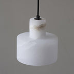 Alabaster pendant light hanging in a softly lit lounge