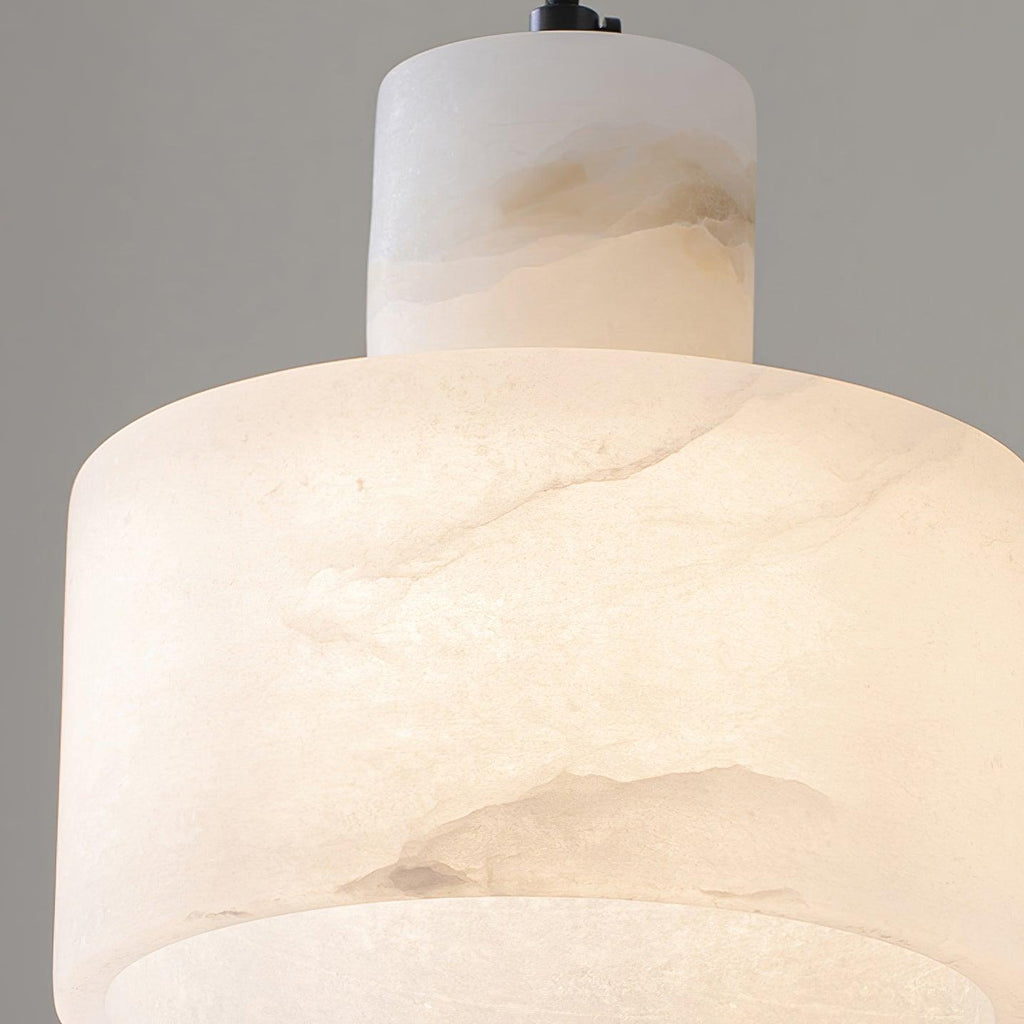 Cluster of alabaster pendant lights at varied heights