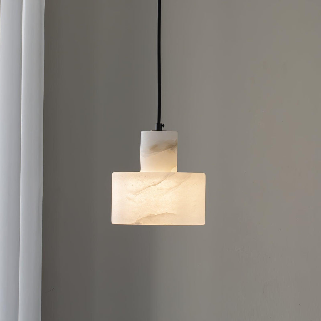 Alabaster pendant light glowing warmly with natural stone veining visible
