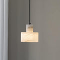 Alabaster pendant light glowing warmly with natural stone veining visible
