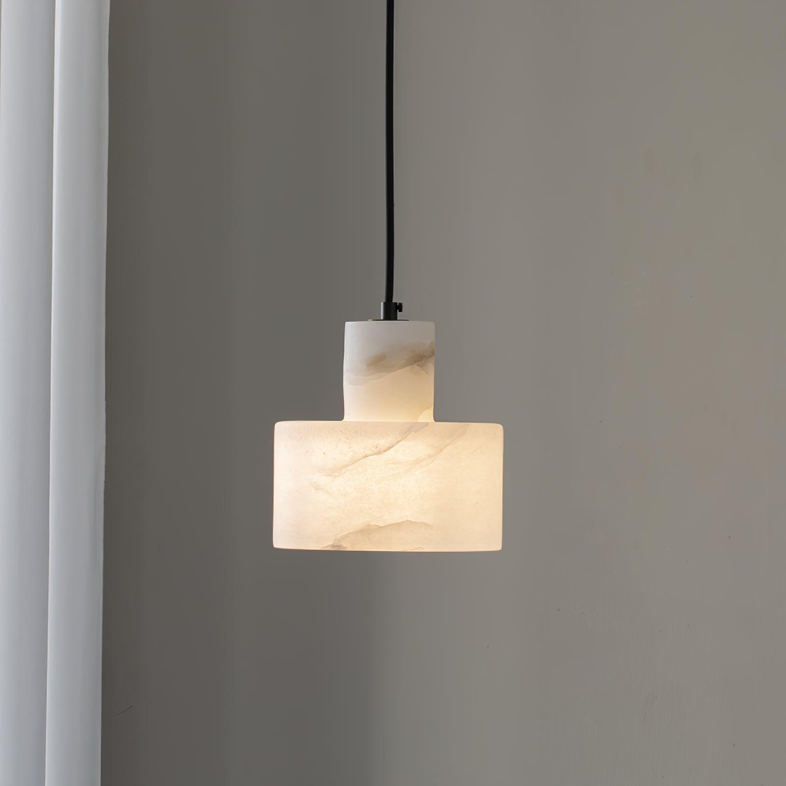Alabaster pendant light glowing warmly with natural stone veining visible