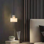 Alabaster pendant light shown unlit, highlighting the polished stone