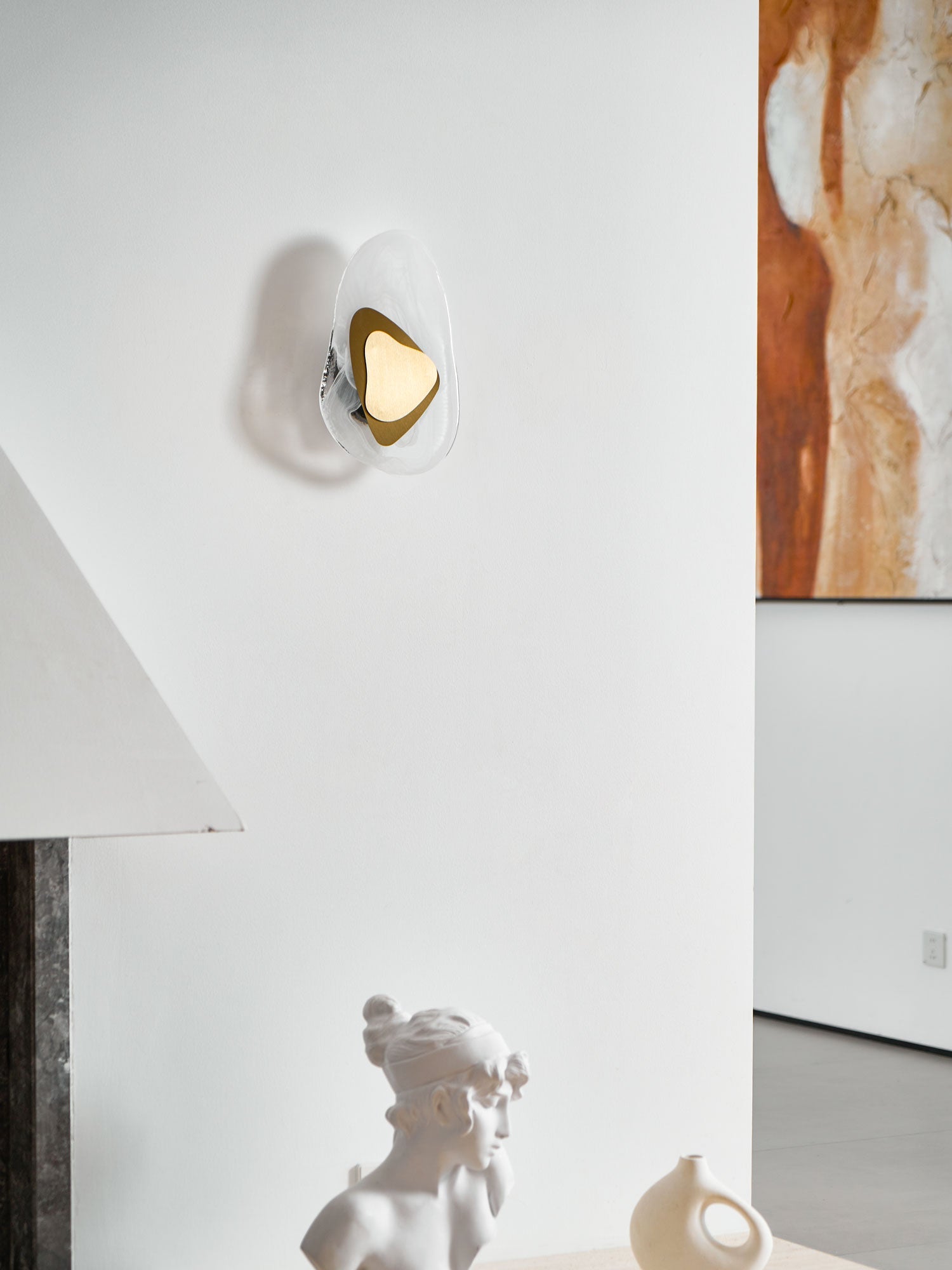 Copper wall lamp casting a warm pool of light