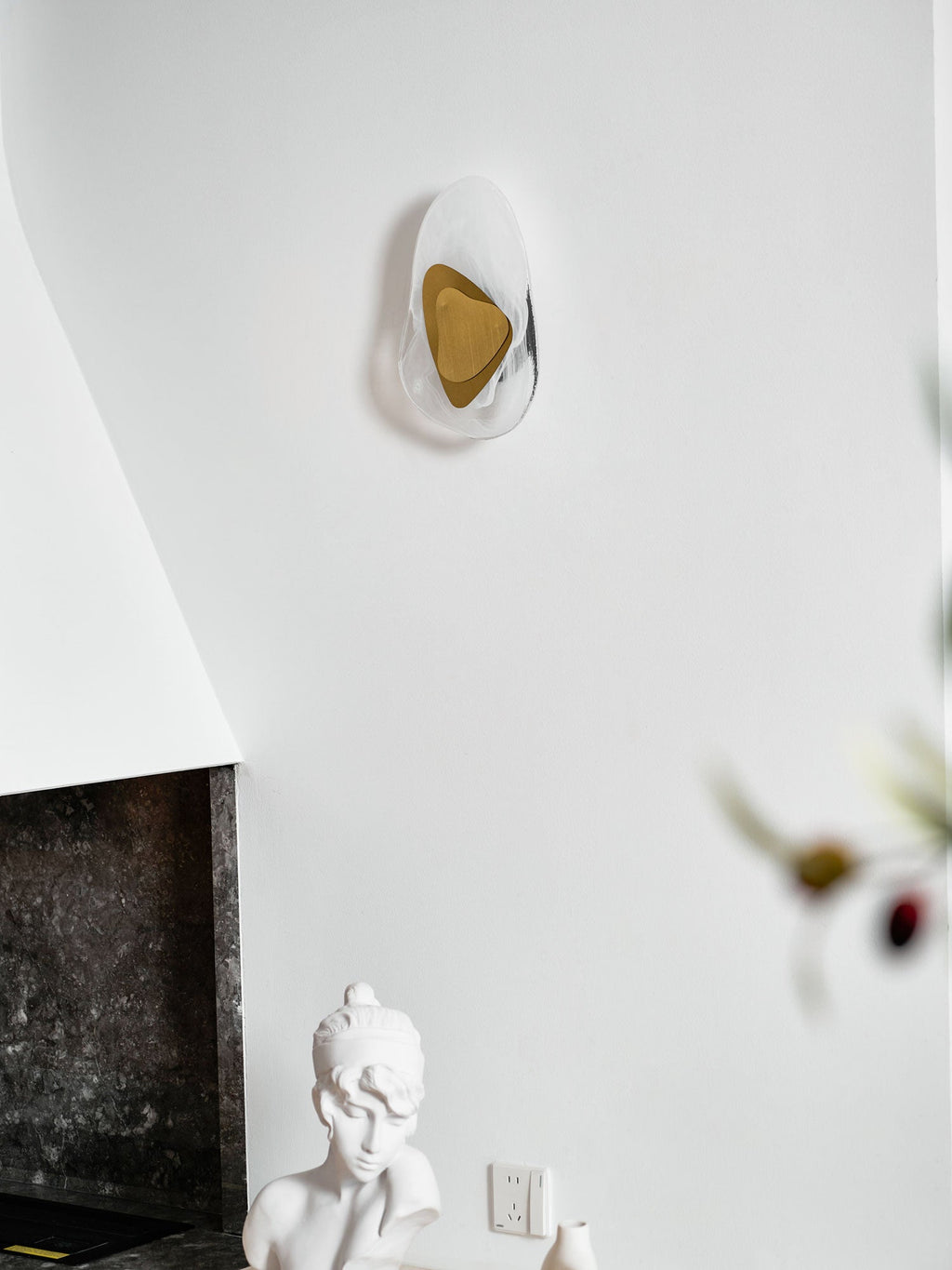Translucent glass wall lamp mounted beside a window