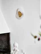 Translucent glass wall lamp mounted beside a window