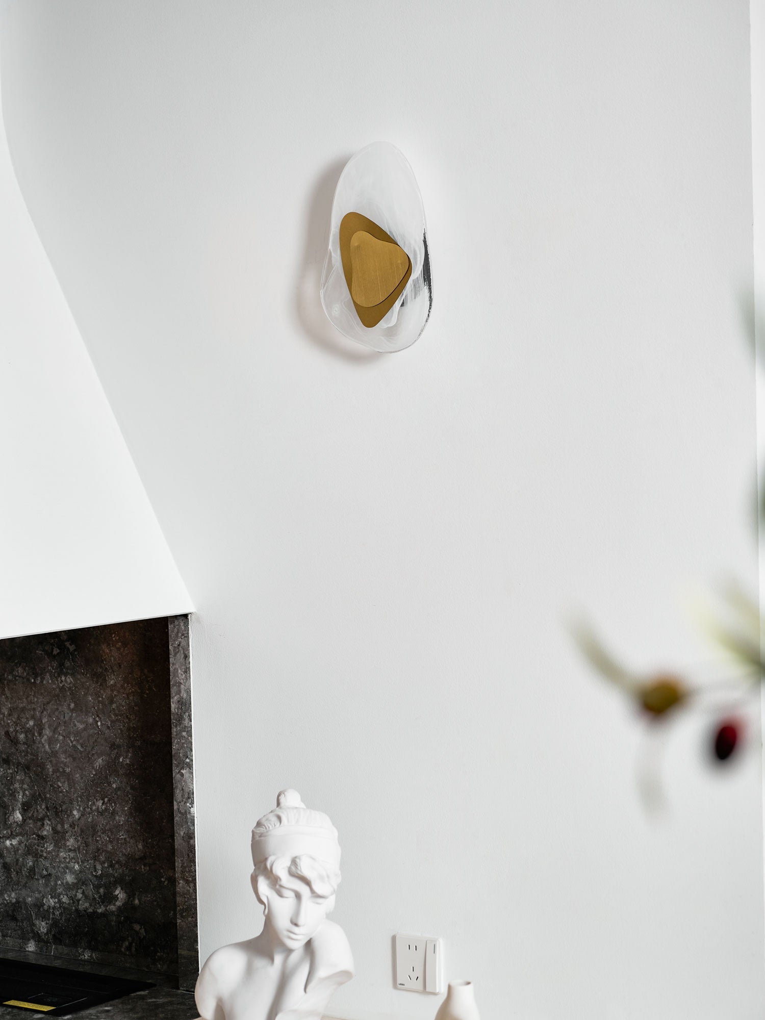 Translucent glass wall lamp mounted beside a window