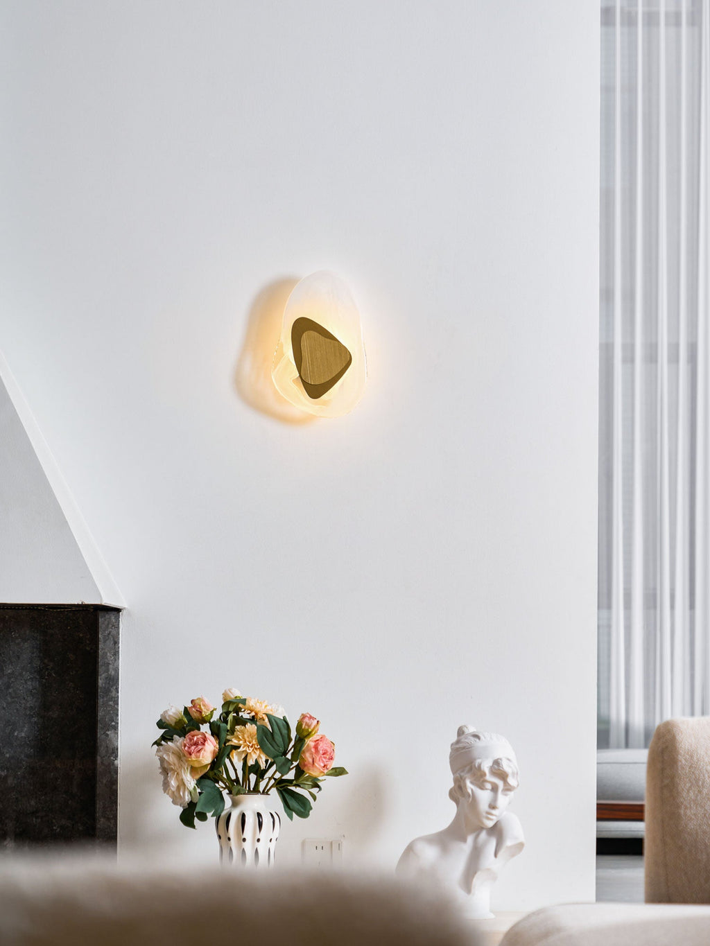 Translucent glass wall lamp lit warmly in an evening room