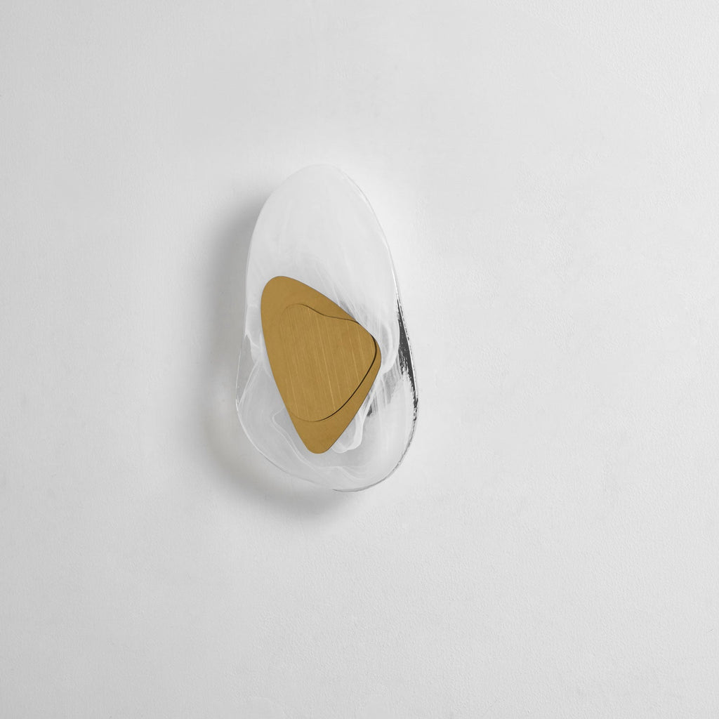 Translucent glass wall lamp lit warmly in a modern home