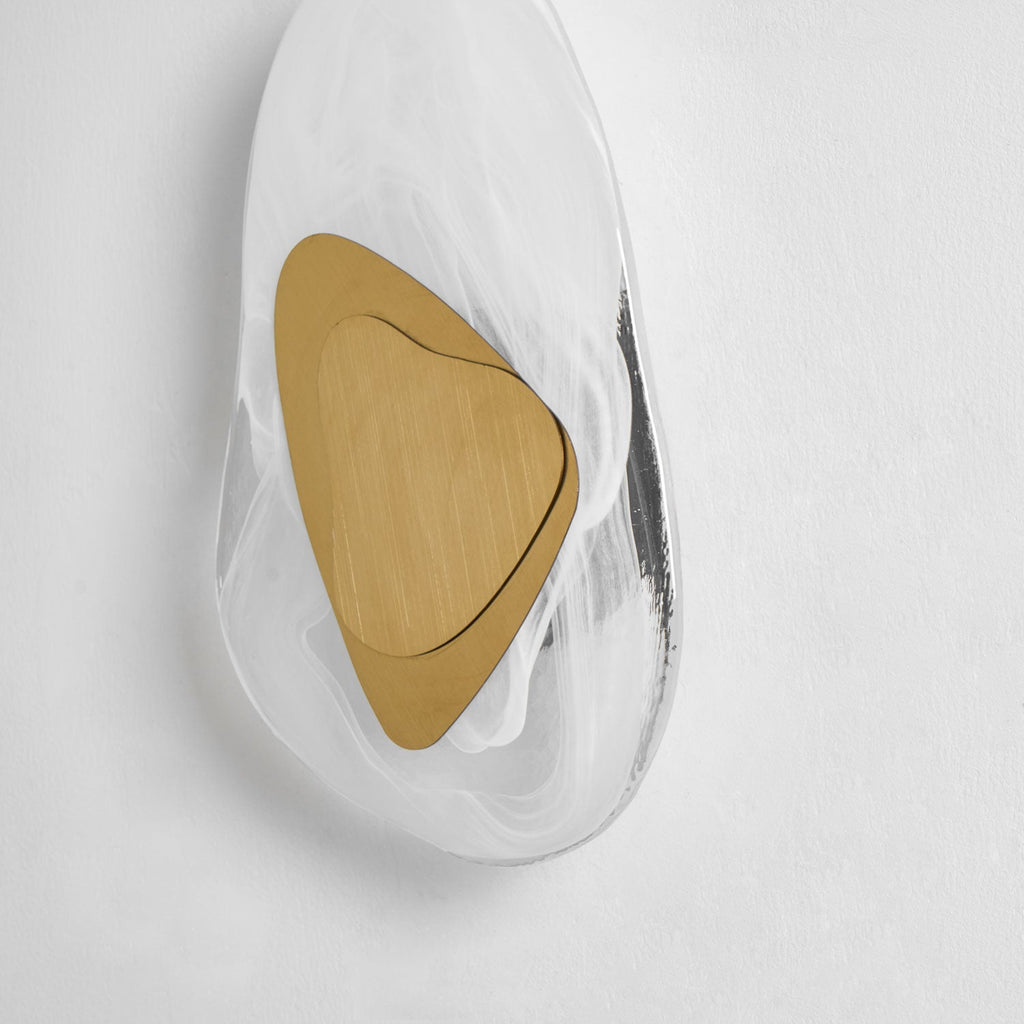 Translucent glass wall lamp glowing softly against a dark wall
