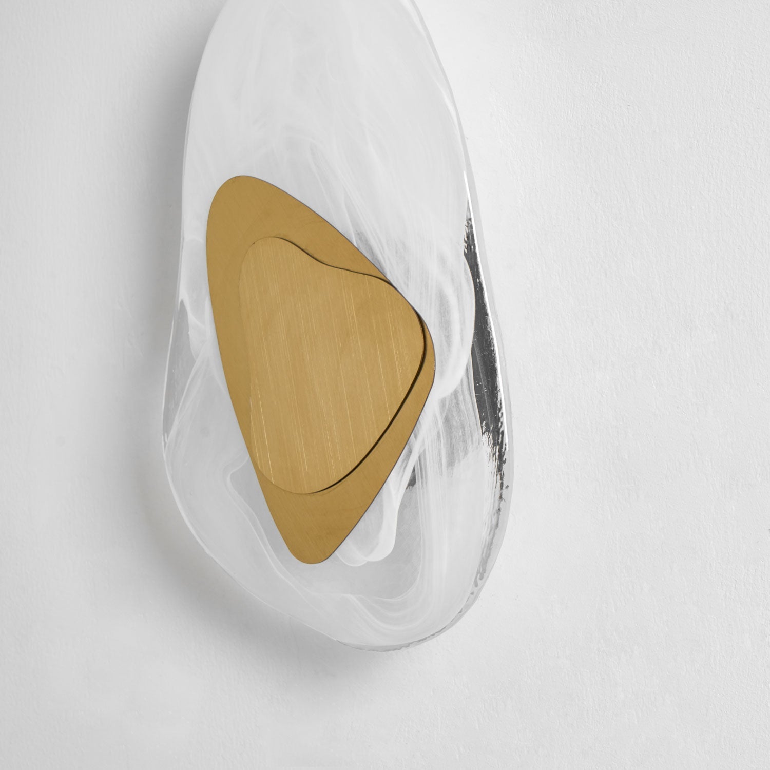 Translucent glass wall lamp glowing softly against a dark wall