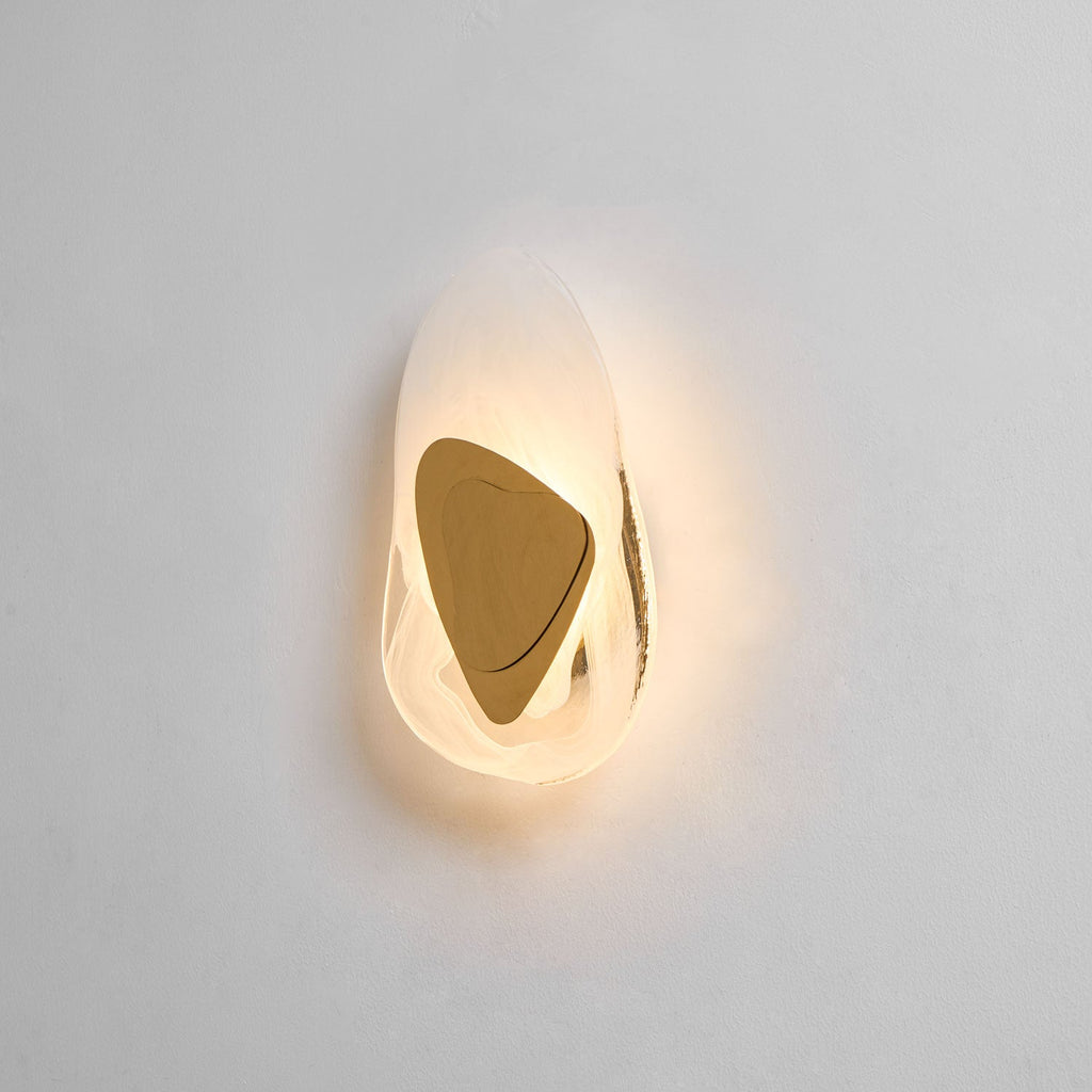 Black wall lamp shown lit and decorative on a plain wall