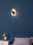 Translucent glass wall lamp glowing beside a seating area