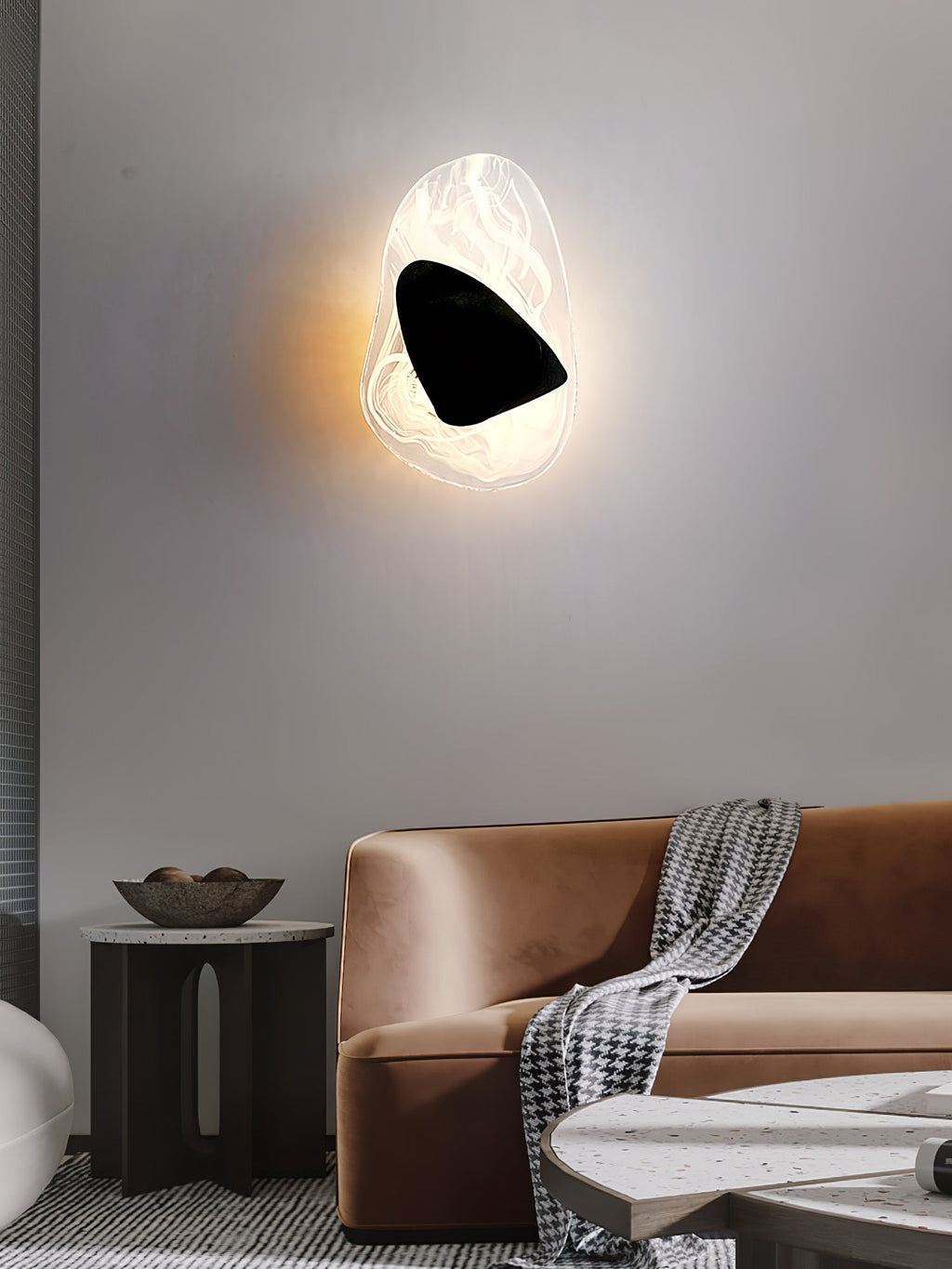 Copper wall lamp shown unlit, highlighting its sculptural shape