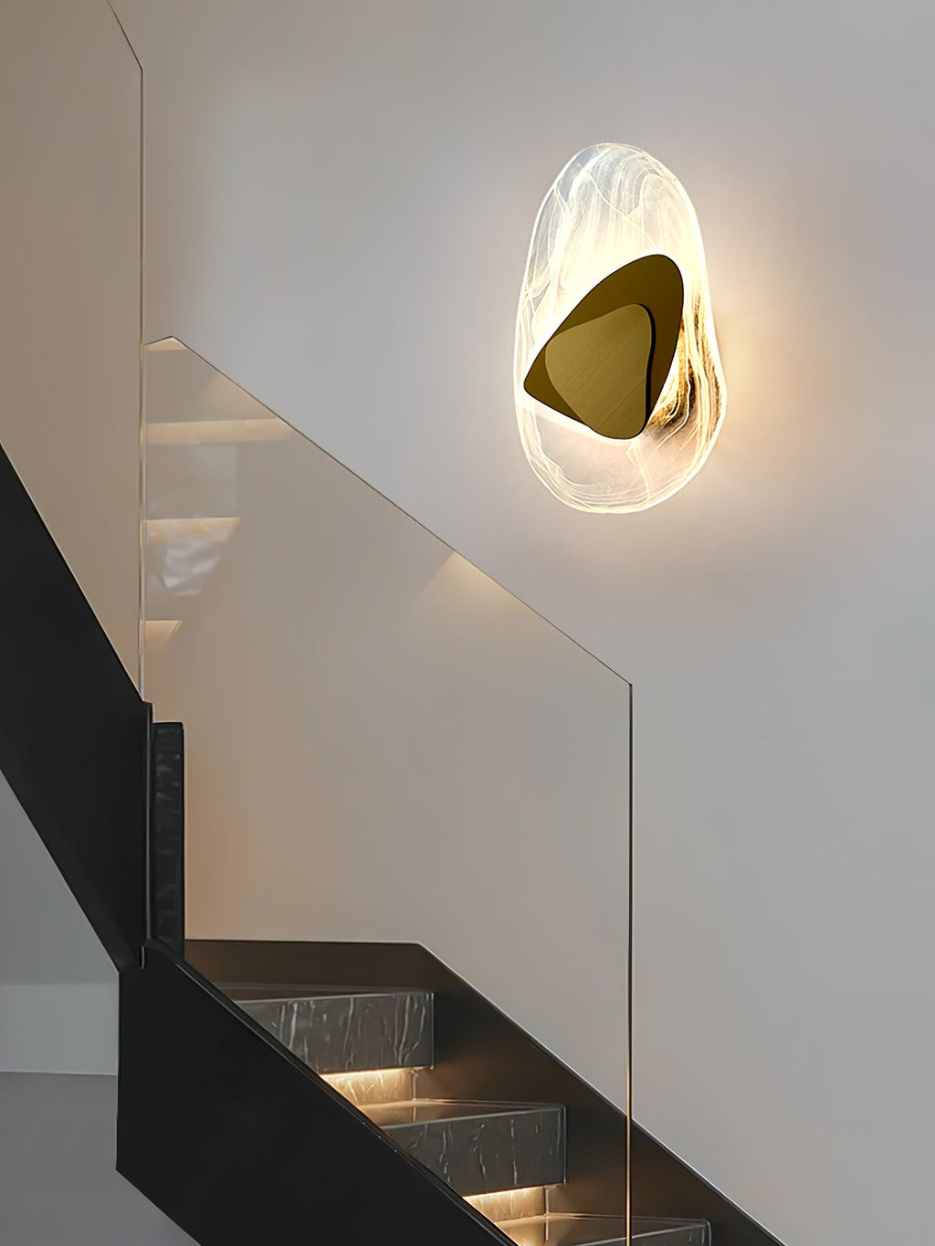 Translucent glass wall lamp lit beside a mirror
