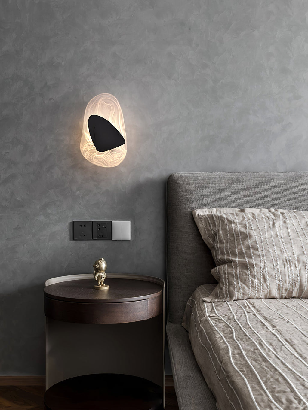 Wall lamp with translucent shade shown close up, glass detail visible