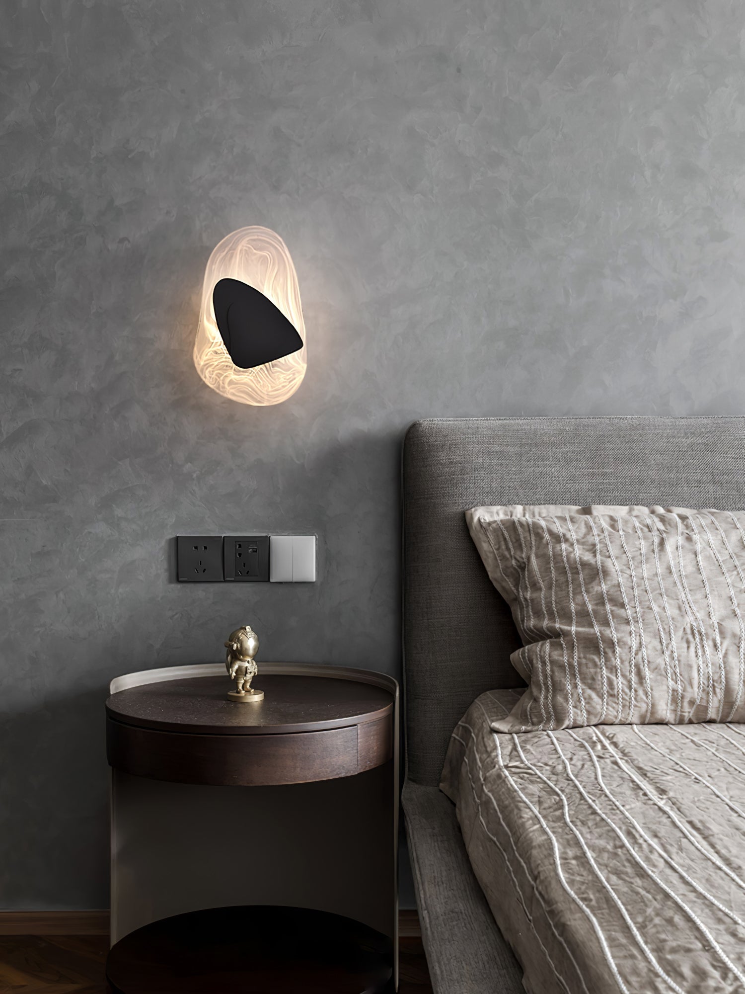 Wall lamp with translucent shade shown close up, glass detail visible