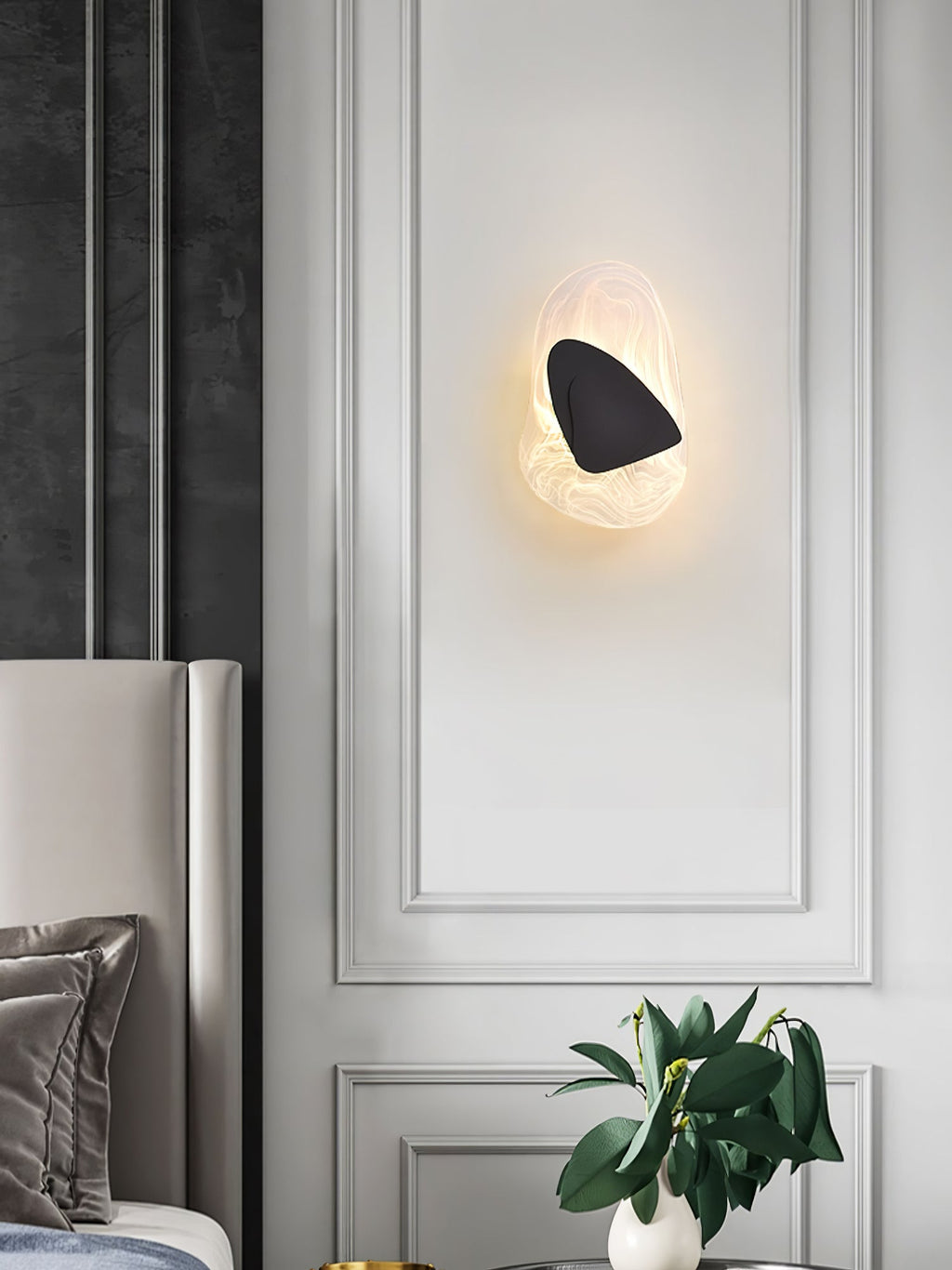 Copper wall lamp lit softly beside a staircase