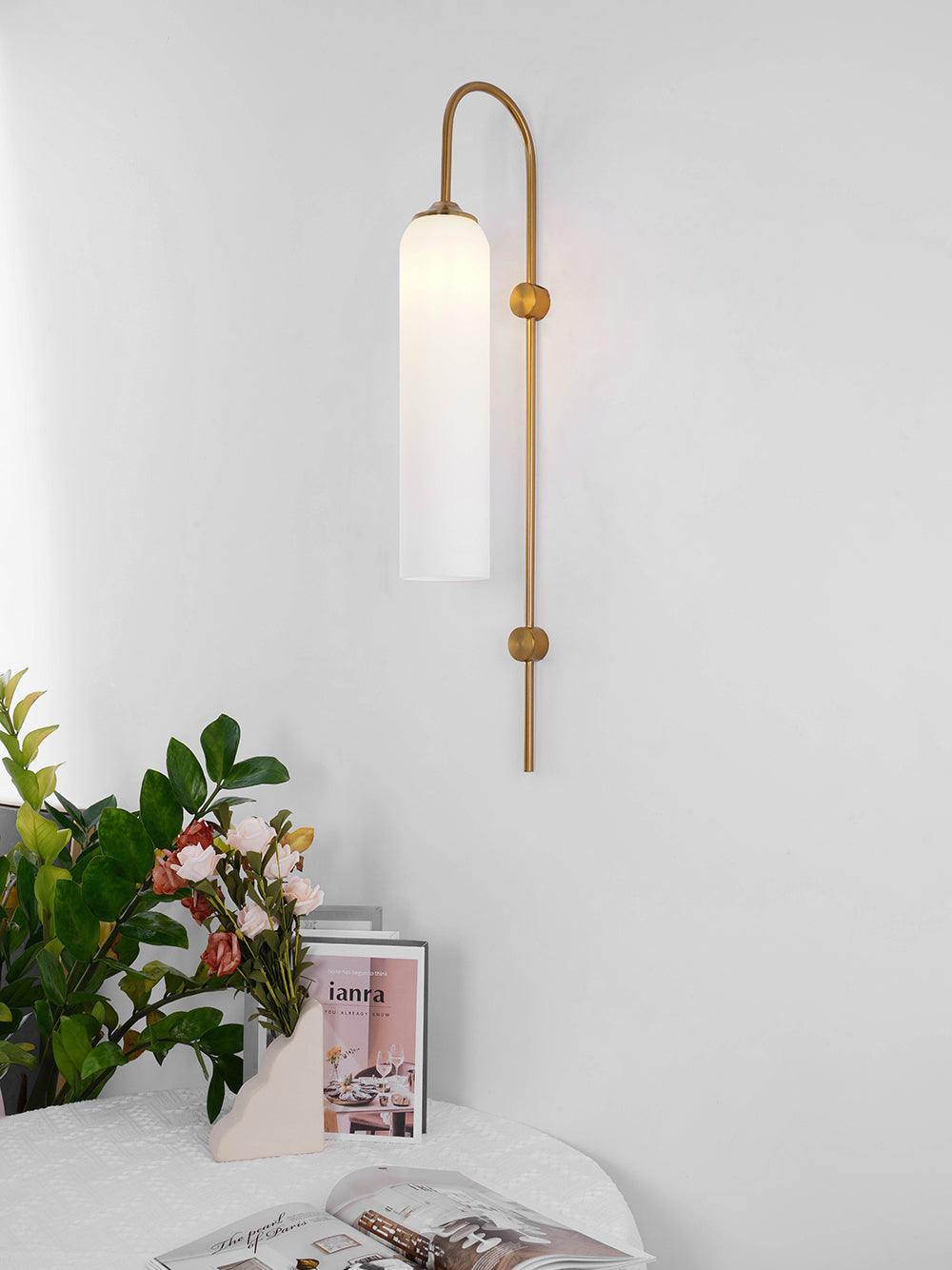Modern glass wall lamp interior detail with brass arm