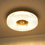 Round flush mount ceiling light with white diffuser glowing
