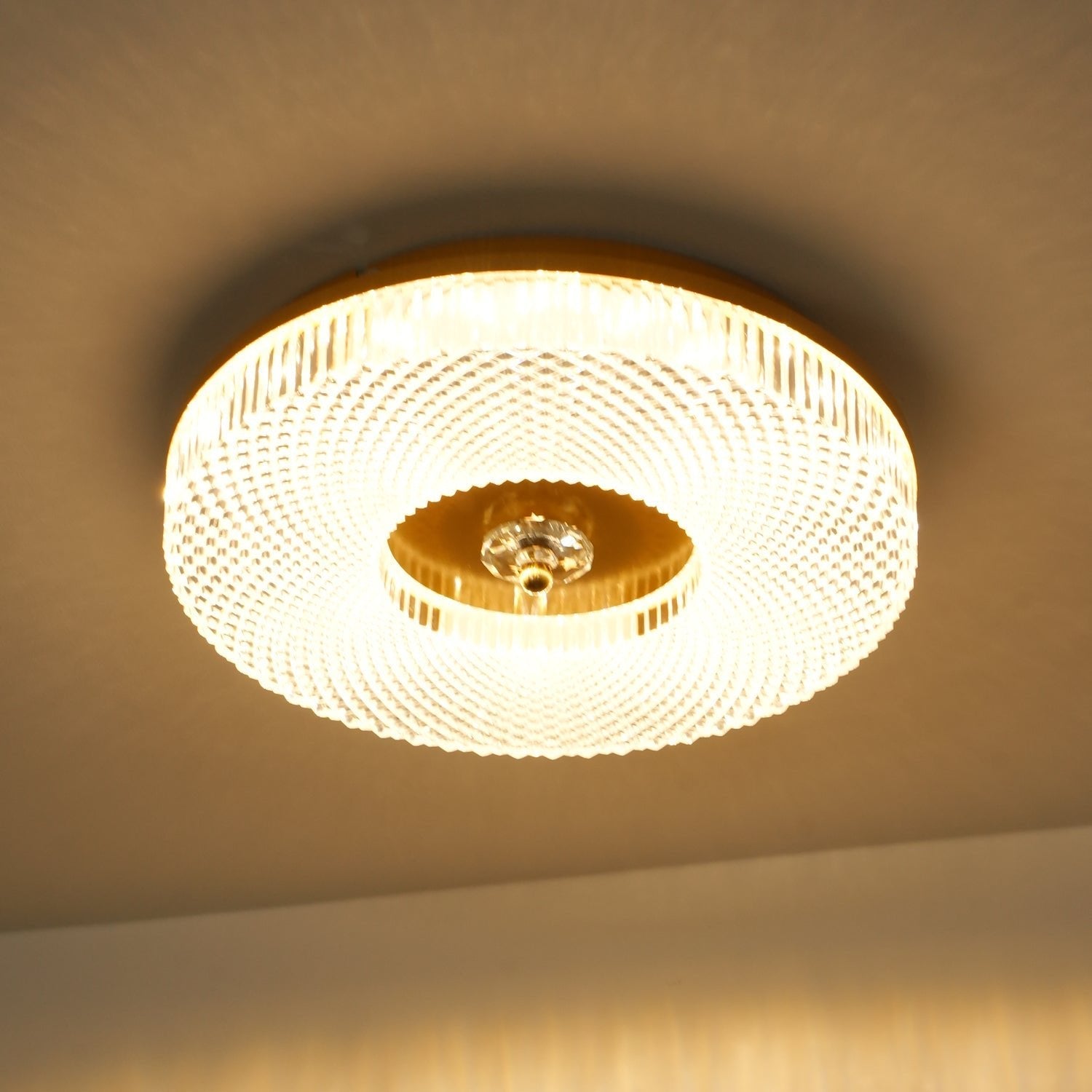Round flush mount ceiling light with white diffuser glowing