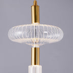 Close view of an angular ribbed glass shade catching light on this Clérachic pendant.