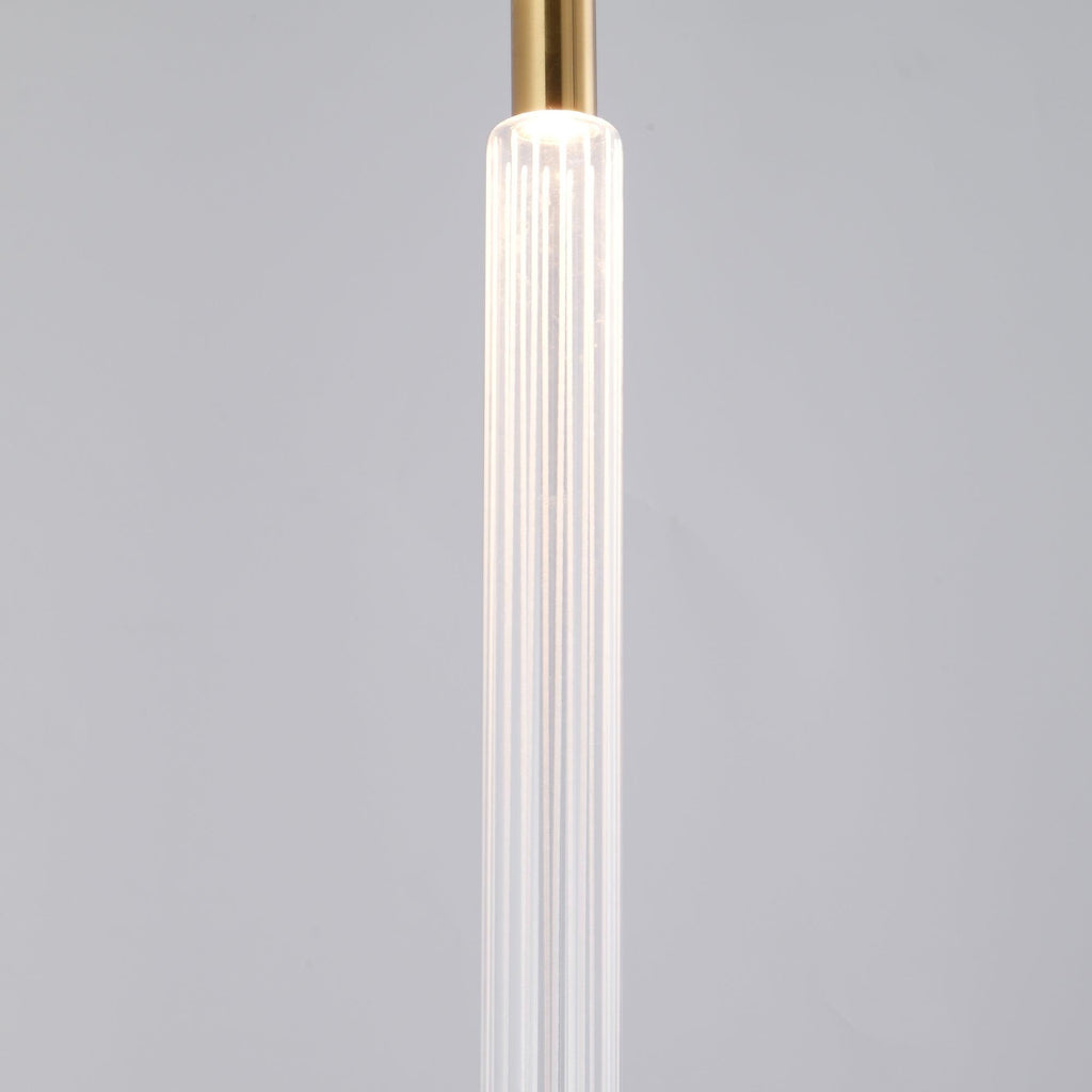 Close view of one ribbed crystal rod on this Clérachic pendant against a plain grey backdrop.
