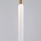 Close view of one ribbed crystal rod on this Clérachic pendant against a plain grey backdrop.