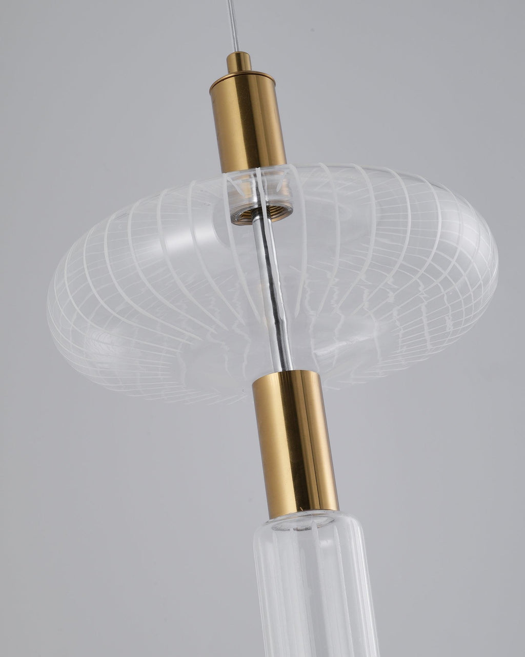 Close view of a woven glass drum shade on this Clérachic pendant's gold rod.