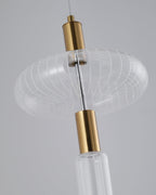 Close view of a woven glass drum shade on this Clérachic pendant's gold rod.