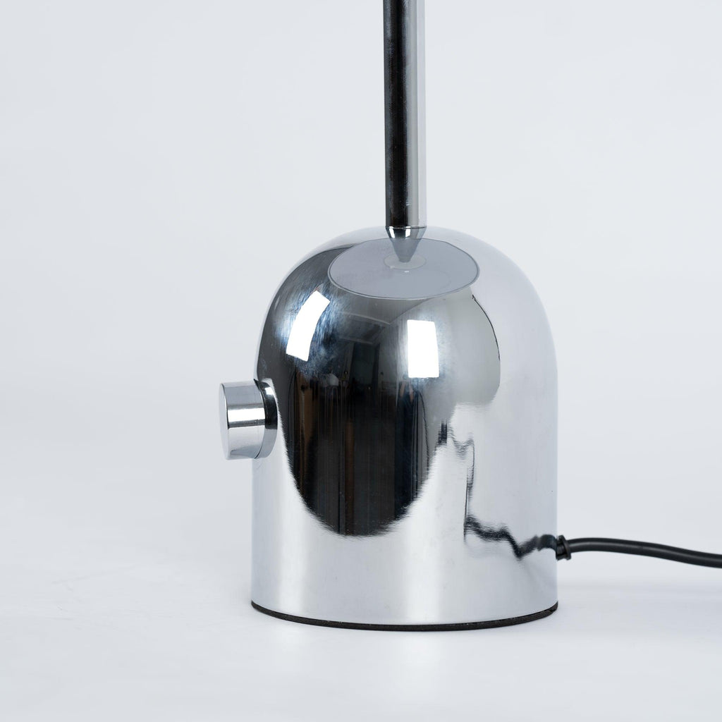 A close-up shows the push-button switch and cord where the dome meets the base on this Clérachic chrome table lamp.