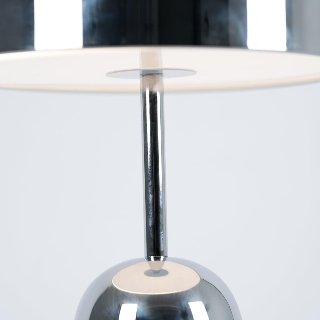 Looking up into the dome shade of this Clérachic chrome table lamp reveals the stem and a white diffuser disc.