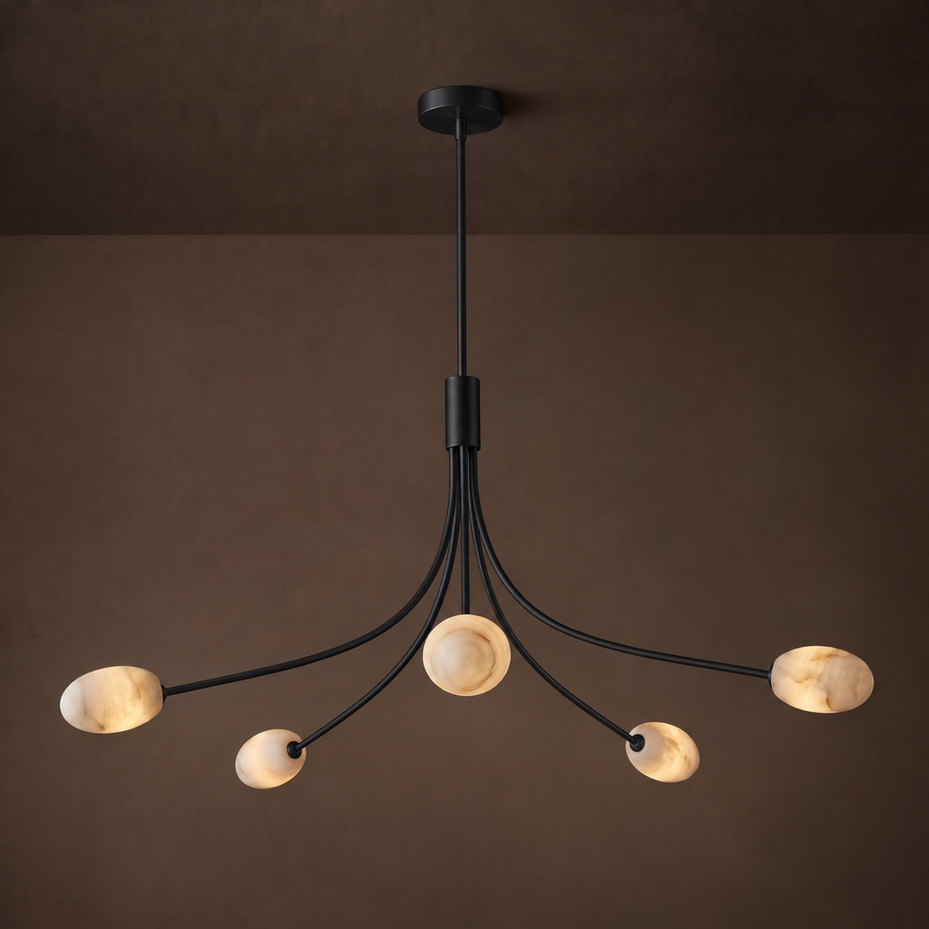 This Clérachic chandelier in matte black stands against a warm brown backdrop, its alabaster discs glowing softly.