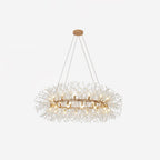 Gold ring chandelier on white, its bulbs ringed by fine wire sprays tipped with clear crystal beads.