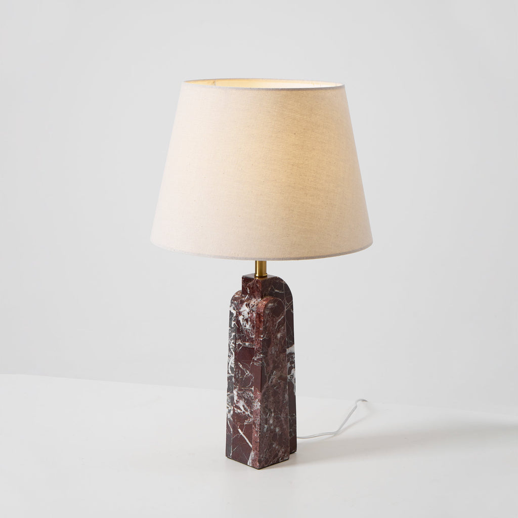 The Clérachic table lamp turned slightly right on a studio background, dark veined marble base and trailing cord.