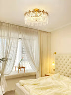 Copper-framed glass petal chandelier in a warm interior setting
