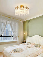 Glass petal chandelier suspended in a high-ceilinged room
