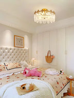 Glass petal chandelier lit, copper frame catching warm light