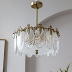 Glass petal chandelier glowing warmly with copper frame visible